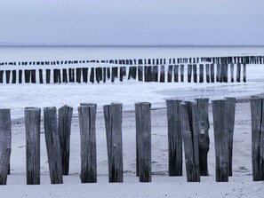 A wooden pier extending into a snowy beach. - Holiday Home in Koudekerke With Wi-fi (Koudekerke)