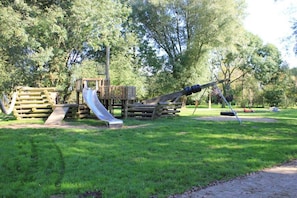 A playground with a slide and climbing structures. - Holiday apartment with 1 bedroom (Otterndorf)
