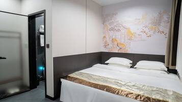 A hotel room with a bed, a wall mural, and a door.