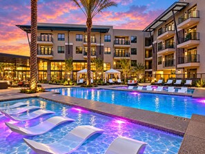 A hotel with a swimming pool, lounge chairs, and a sunset sky. - Scottsdale Retreat Near Old Town & Fashion Square (Scottsdale)