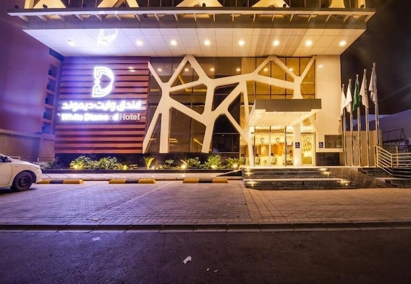 A hotel entrance with a modern design, featuring a prominent logo and a well-lit facade. - Wow Diamond Hotel (Jeddah)