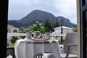 A table set for breakfast with a mountain view.