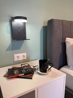 A room with a white desk, a black mug, a pair of glasses, and a book titled 'Ancient Carthage.'