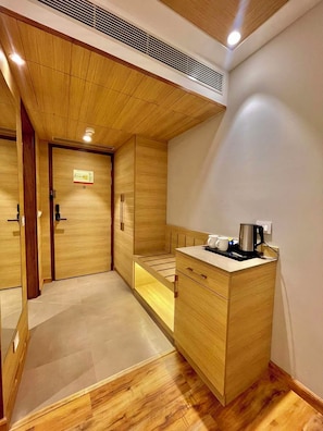 A compact room with a wooden ceiling, a kitchenette with a coffee maker, and a small seating area. - Best Western Kasauli (Kasauli)