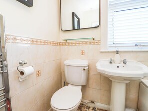 Ein Badezimmer mit Toilette, Waschbecken und Spiegel.