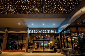 The exterior of a hotel with a modern design, featuring a prominent entrance and a ceiling with a pattern of lights. - Novotel Uberlandia (Uberlandia)