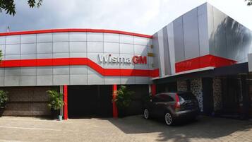 A building with a modern design, featuring a prominent 'Wisma GM' sign.