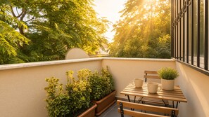 A balcony with a wooden table, two chairs, and potted plants. - 3-Storey Townhouse with Sauna, Bar, Terrace, 3BR,3BA (Beyoğlu)