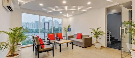 A modern office space with a curved ceiling, large windows, and a view of a cityscape.