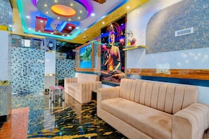 A lobby with a Buddha statue, plush seating, and a colorful ceiling. - Hotel Kanan Inn - Kolkata Airport (Barakpur)
