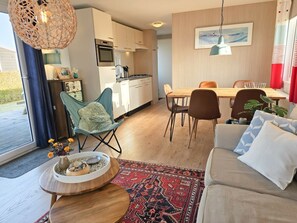 A modern interior with a dining area, kitchen, and seating space. - Se16 Serooskerke (Serooskerke)
