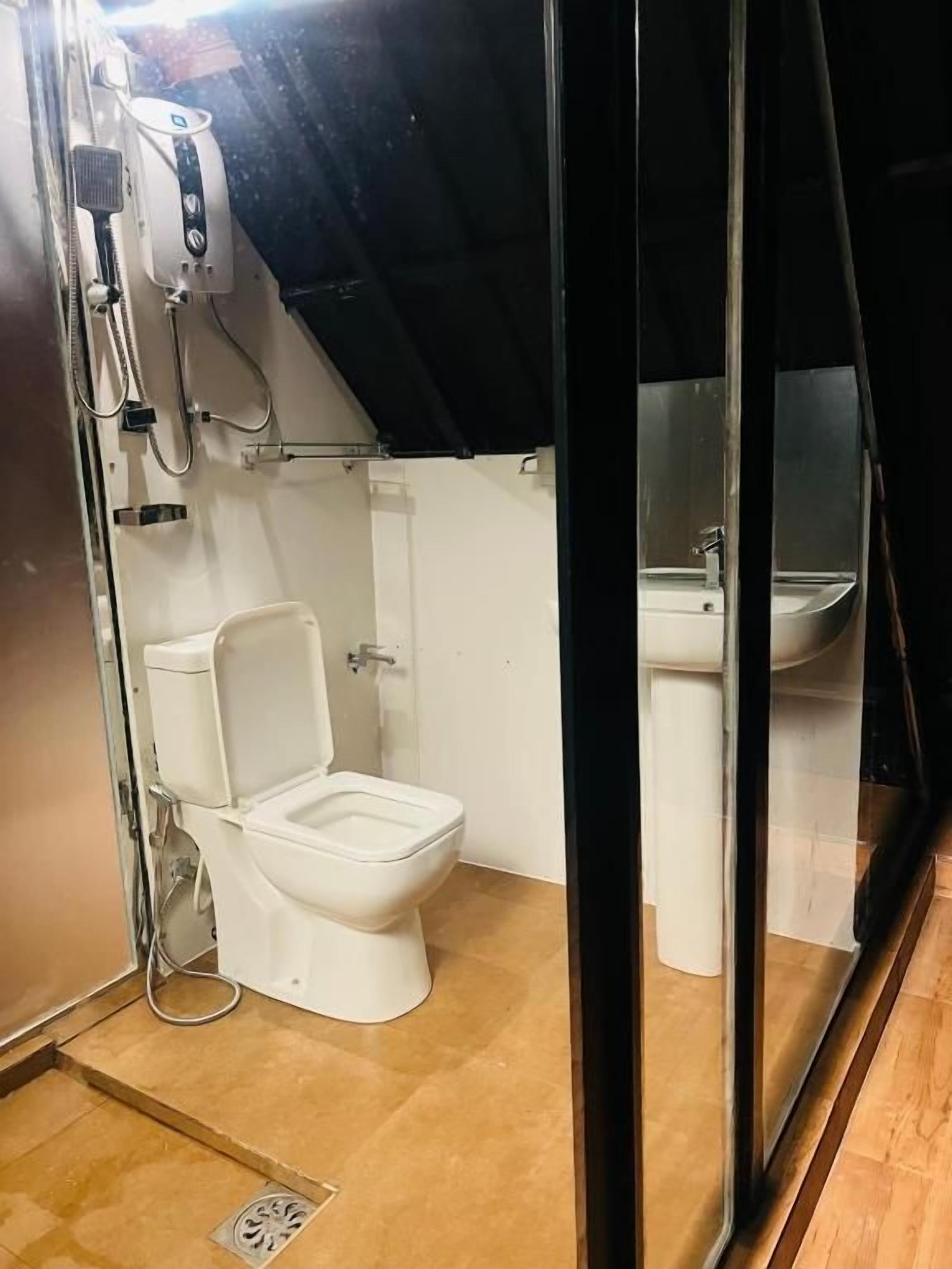 A compact bathroom with a toilet, bidet, and sink.