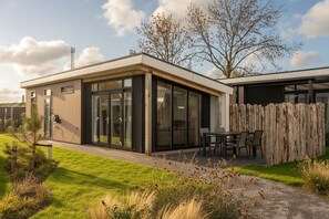 A modern house with a patio, large windows, and a wooden fence. - Enjoying each other and the oyster culture in Yerseke, Zeeland (Yerseke)
