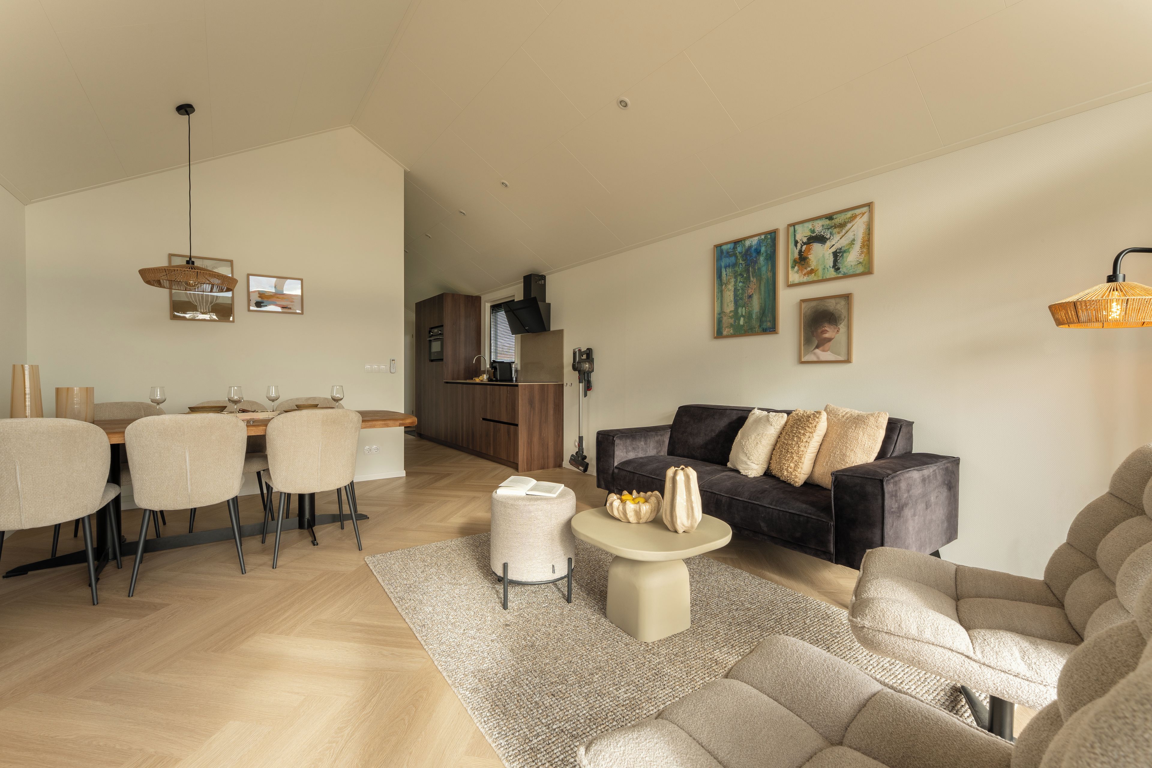 A modern living room with a sofa, coffee table, and dining area with chairs.