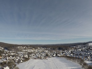 A snow-covered landscape with a town in the foreground and a clear sky above. - Holiday Apartment With 4 Bedrooms (Braunlage)