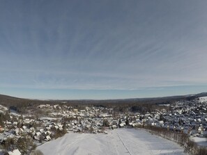 A snow-covered landscape with a town in the foreground and a clear sky above. - Holiday Apartment With 4 Bedrooms (Braunlage)