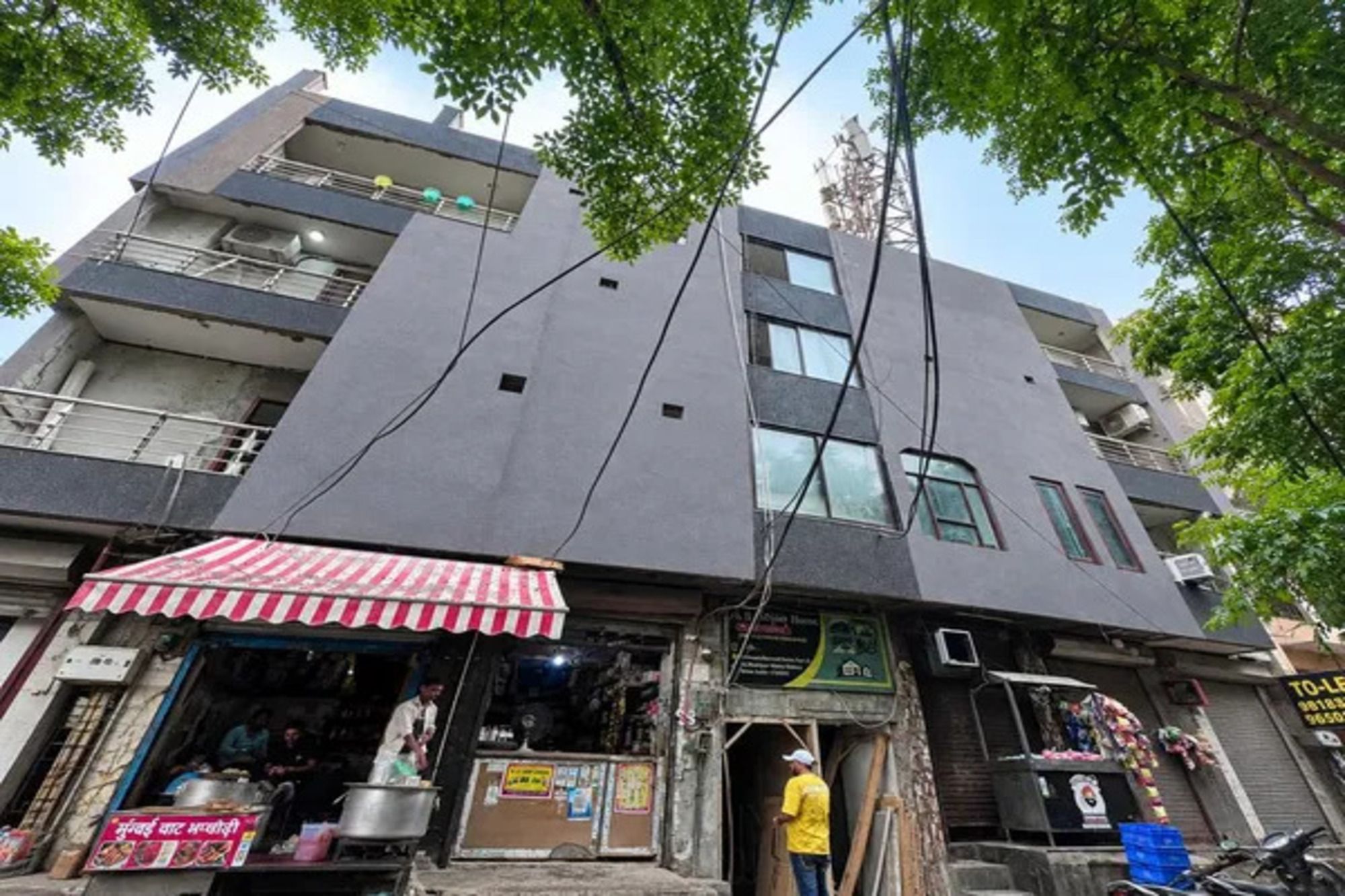 A multi-story building with a storefront at the ground level.