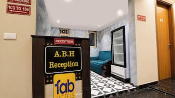 A reception area with a sign for A.B.H Reception and a 'fab hotels' logo.