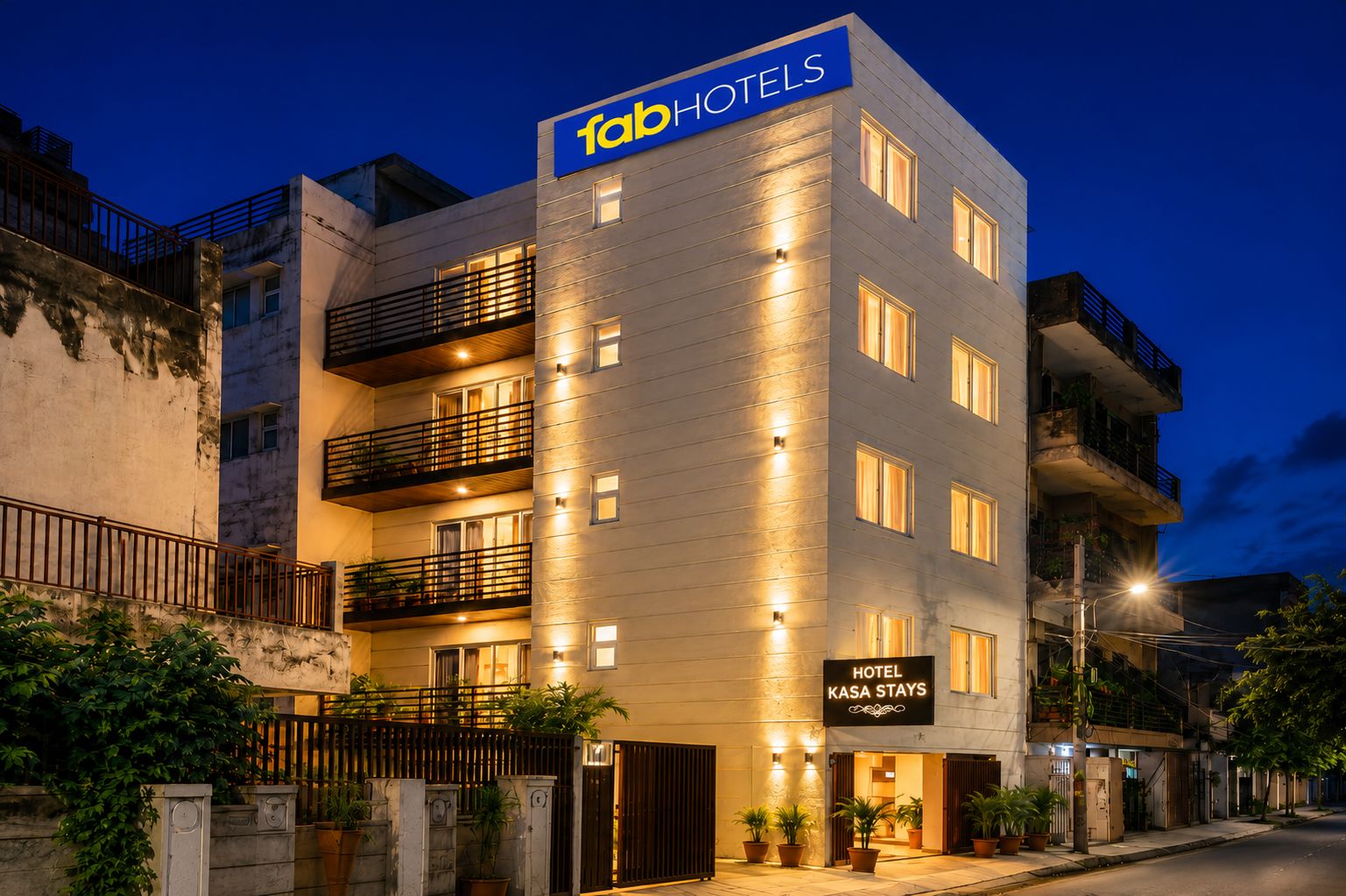 A multi-story hotel building with a prominent sign reading 'fabHOTELS' and a smaller sign below stating 'HOTEL KASA STAYS'.