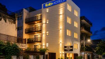 A multi-story hotel building with a prominent sign reading 'fabHOTELS' and a smaller sign below stating 'HOTEL KASA STAYS'.