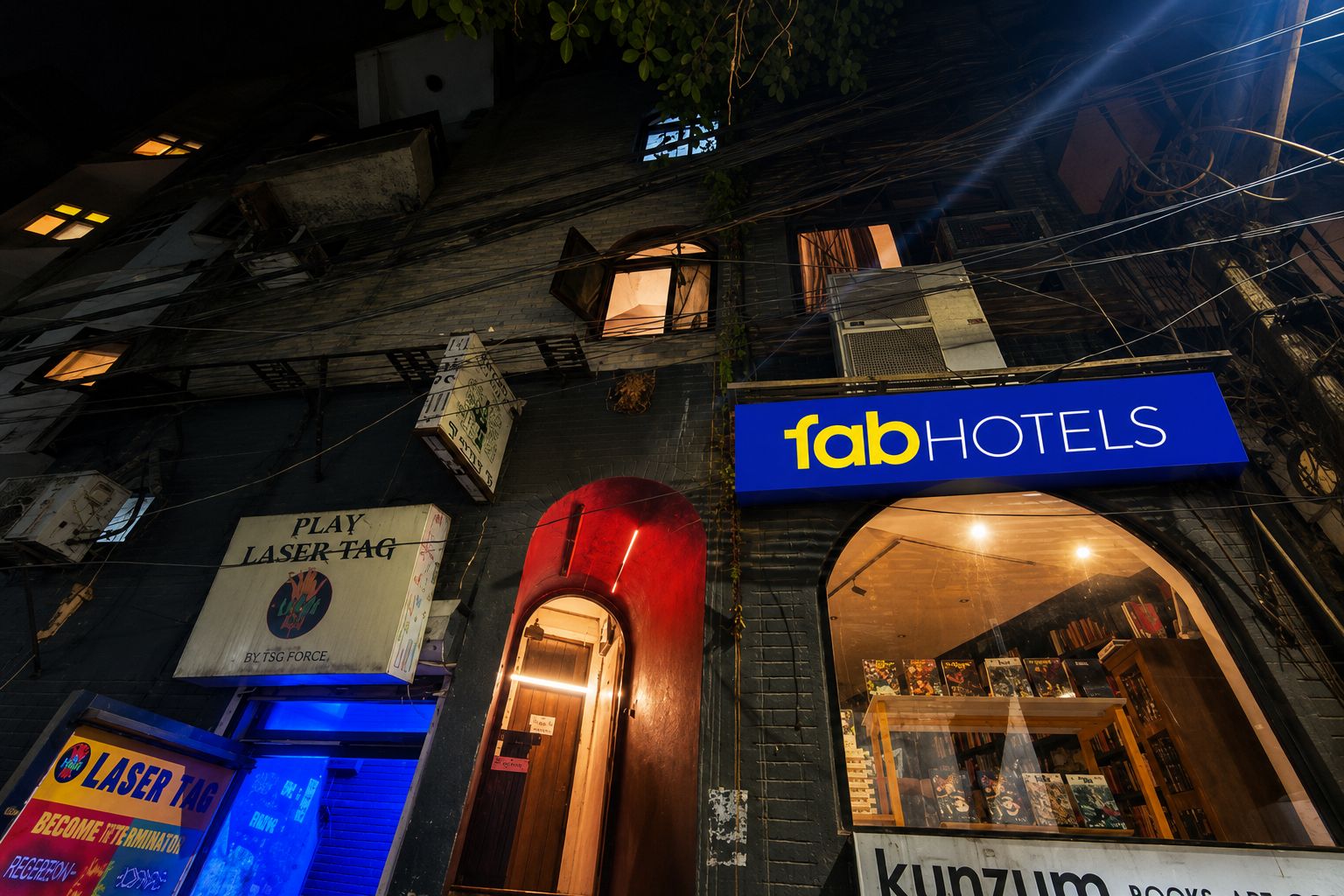 A building with a sign for 'fabHOTELS' and a visible entrance.