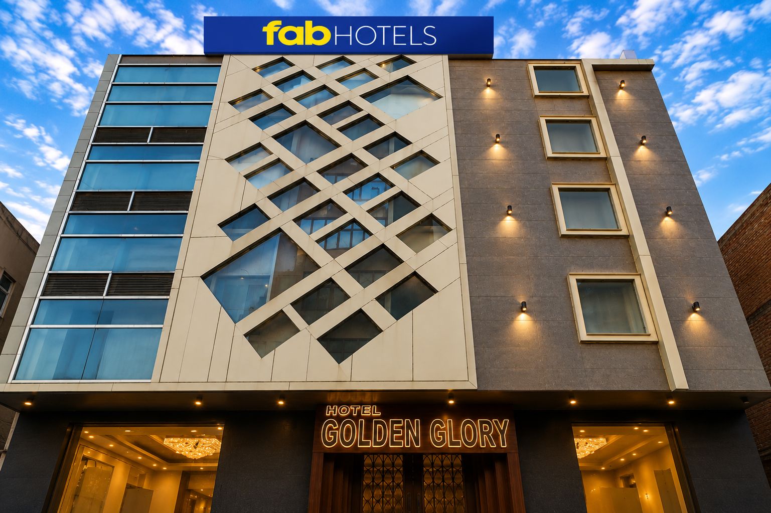 A modern hotel facade with a prominent 'fab HOTELS' sign and 'HOTEL GOLDEN GLORY' signage.