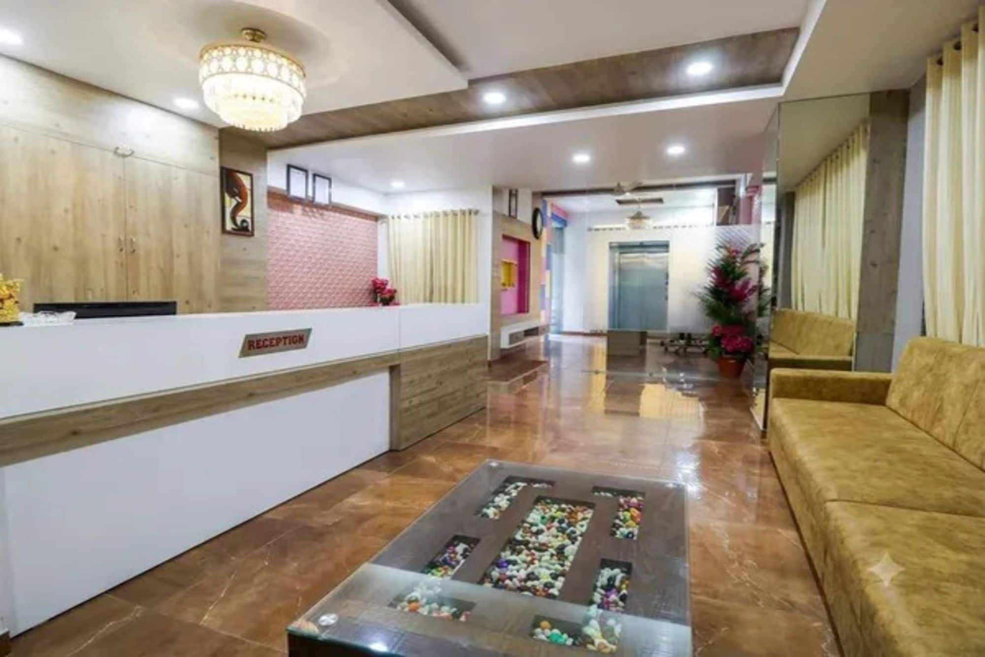 A reception area with a reception desk, a waiting area with a sofa, and a decorative glass coffee table.