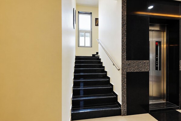 Un intérieur moderne avec un escalier menant à un ascenseur.