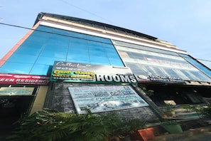 A hotel with a large glass facade, a sign for 'Green Residency Classic A/C Rooms', and a 'Rathna's Kitchen' sign. - FabHotel K Hotels (Bangalore)