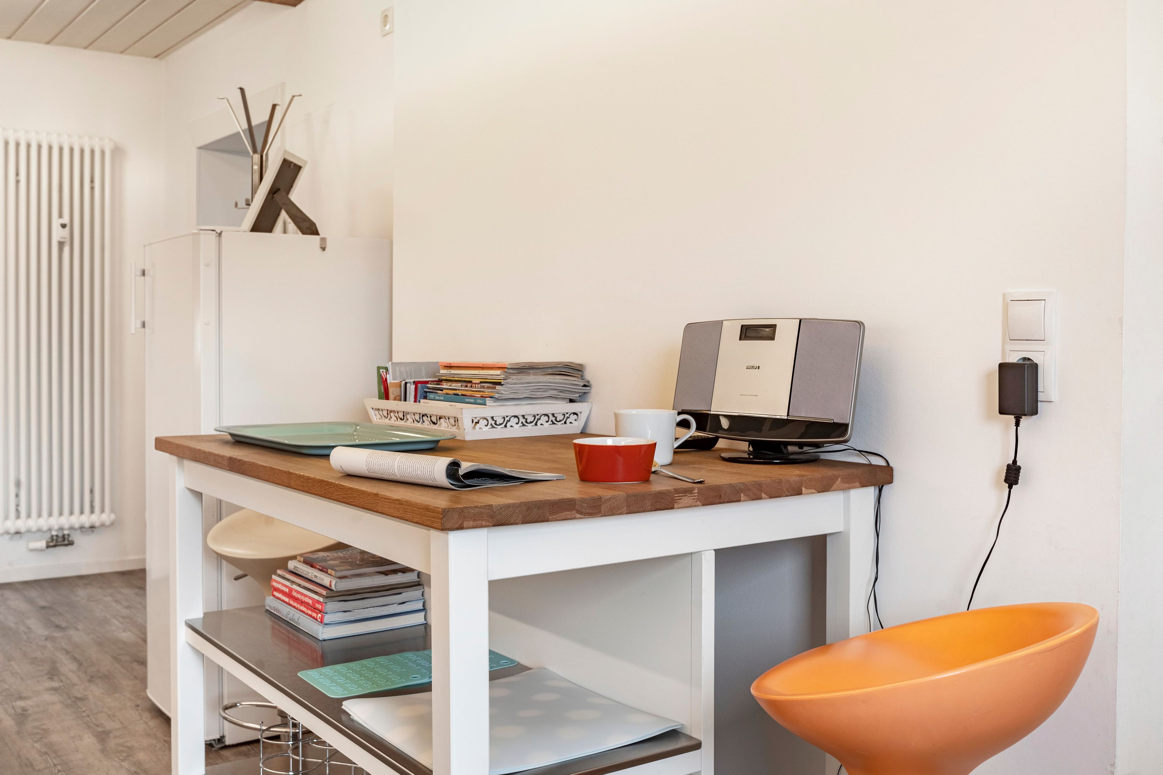 A modern workspace with a wooden desk, a computer, and various office supplies.