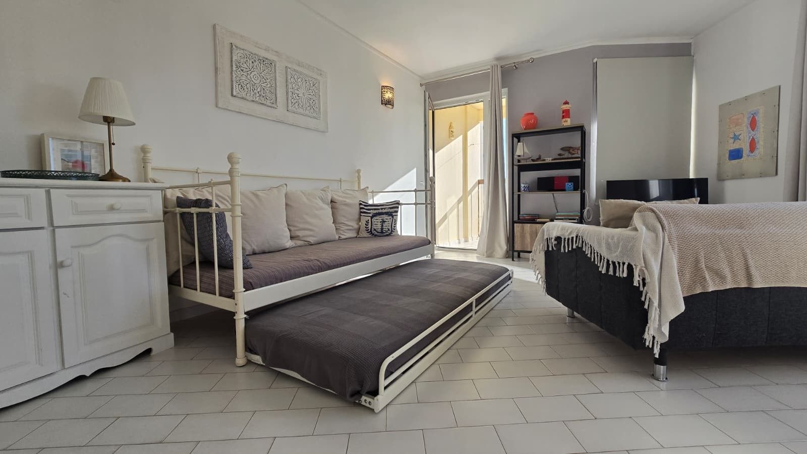 Ein Schlafzimmer mit einem Bett, einem Schreibtisch, einem Stuhl und einem Kleiderschrank.