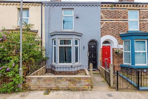 A row of terraced houses with distinct architectural styles, including a corner bay window and a red door. - Contractors | Families & Leisure | 3 Bed | Sleeps 6 | Bootle (Bootle)