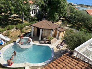A swimming pool with a hot tub, lounge chairs, and a gazebo. - Villa Agata Ground Floor With Pool & Sauna (Rab)