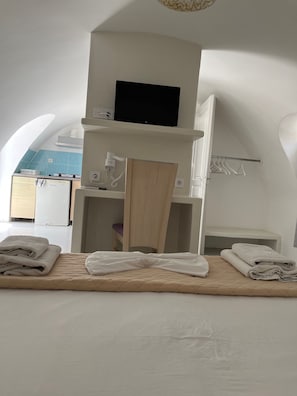 A bedroom with a bed, a wooden chair, a TV, and a small table. - Studio Apartment 'Double Room - 302' with Sea View, Wi-Fi and Air Conditioning (Εμπορείο)