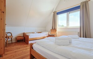 A bedroom with two wooden beds, a chair, and a window with curtains. - Watersnip - Enjoying the water (Lemmer)