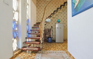 A staircase with a patterned carpet leading to a room with a refrigerator and a globe on top. - Aquarium | 20 Persons | 10 Bathrooms & Bedrooms | Monschau, DE (Monschau)