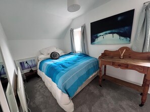 A bedroom with a bed, a desk, a painting, and a window. - Mountainside Cottage, Dingle Wild Atlantic Way , Ireland (Dingle)