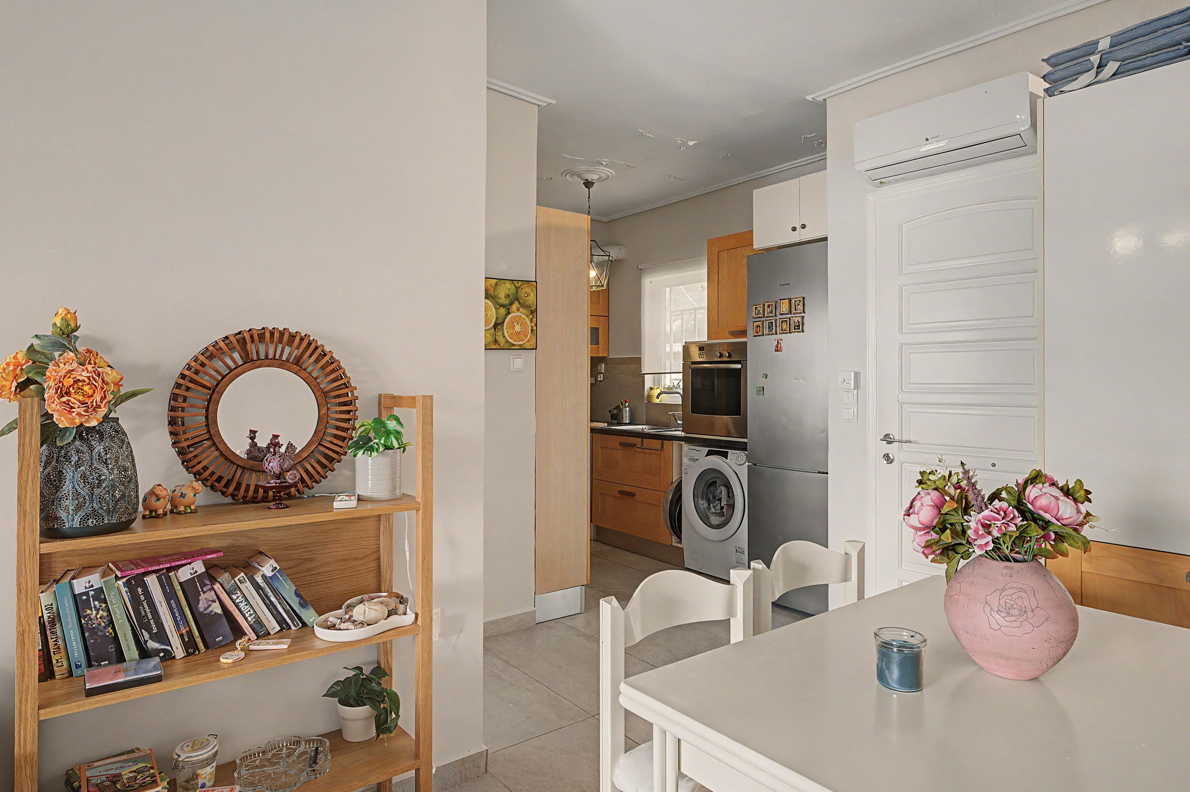 Une cuisine moderne équipée d’un four encastré, d’un four à micro-ondes et d’un lave-linge.