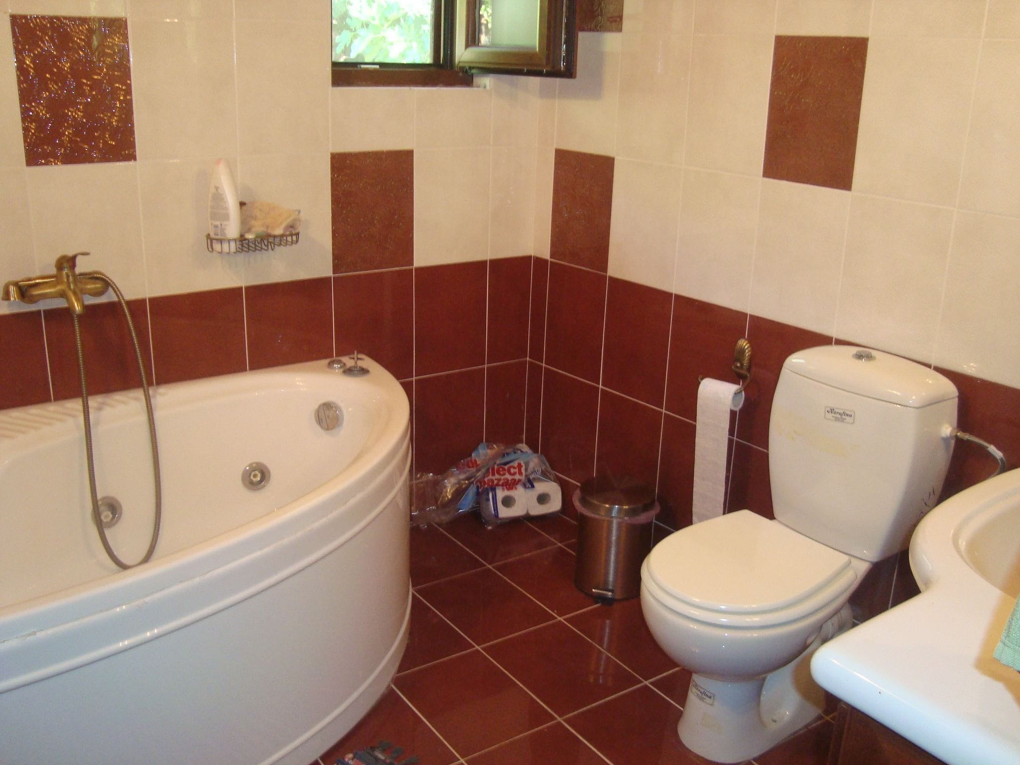 A bathroom with a bathtub, toilet, and shower.