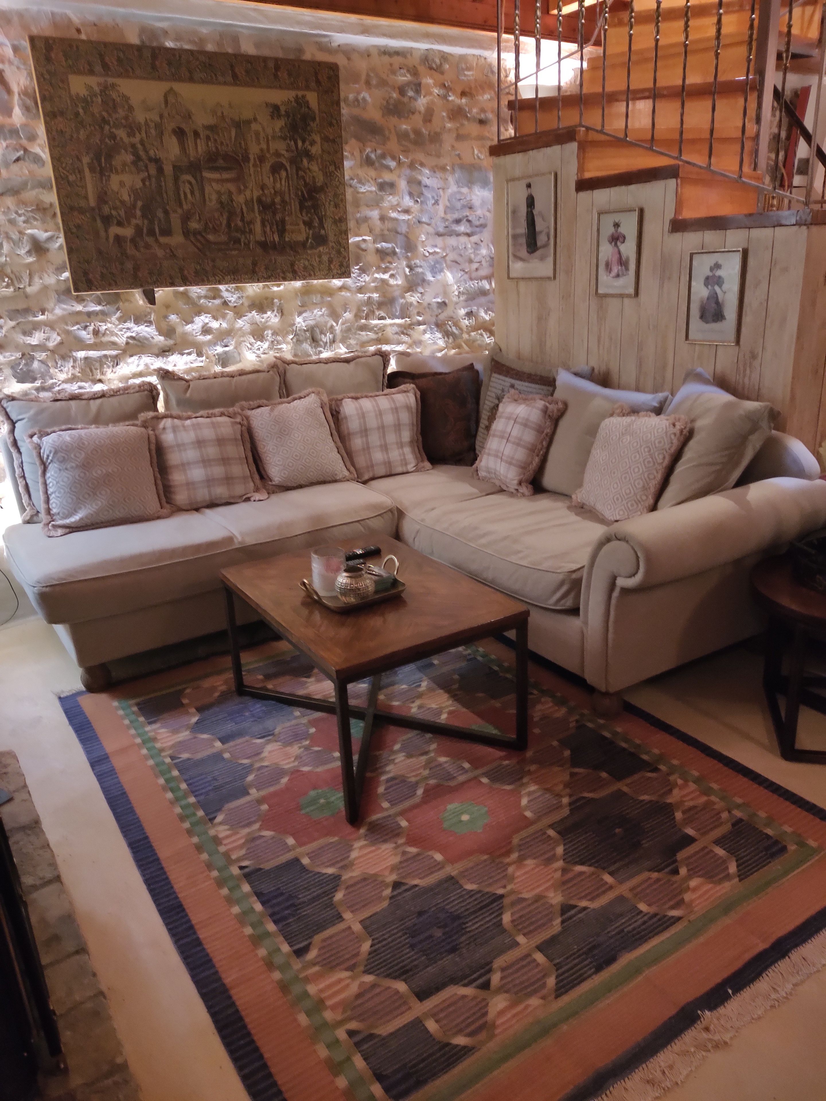 A cozy living room with a sofa, a coffee table, and a patterned rug.