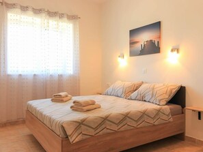 A bedroom with a bed, curtains, a wall-mounted picture, and bedside lamps. - Dvori With Private Pool (Liznjan)