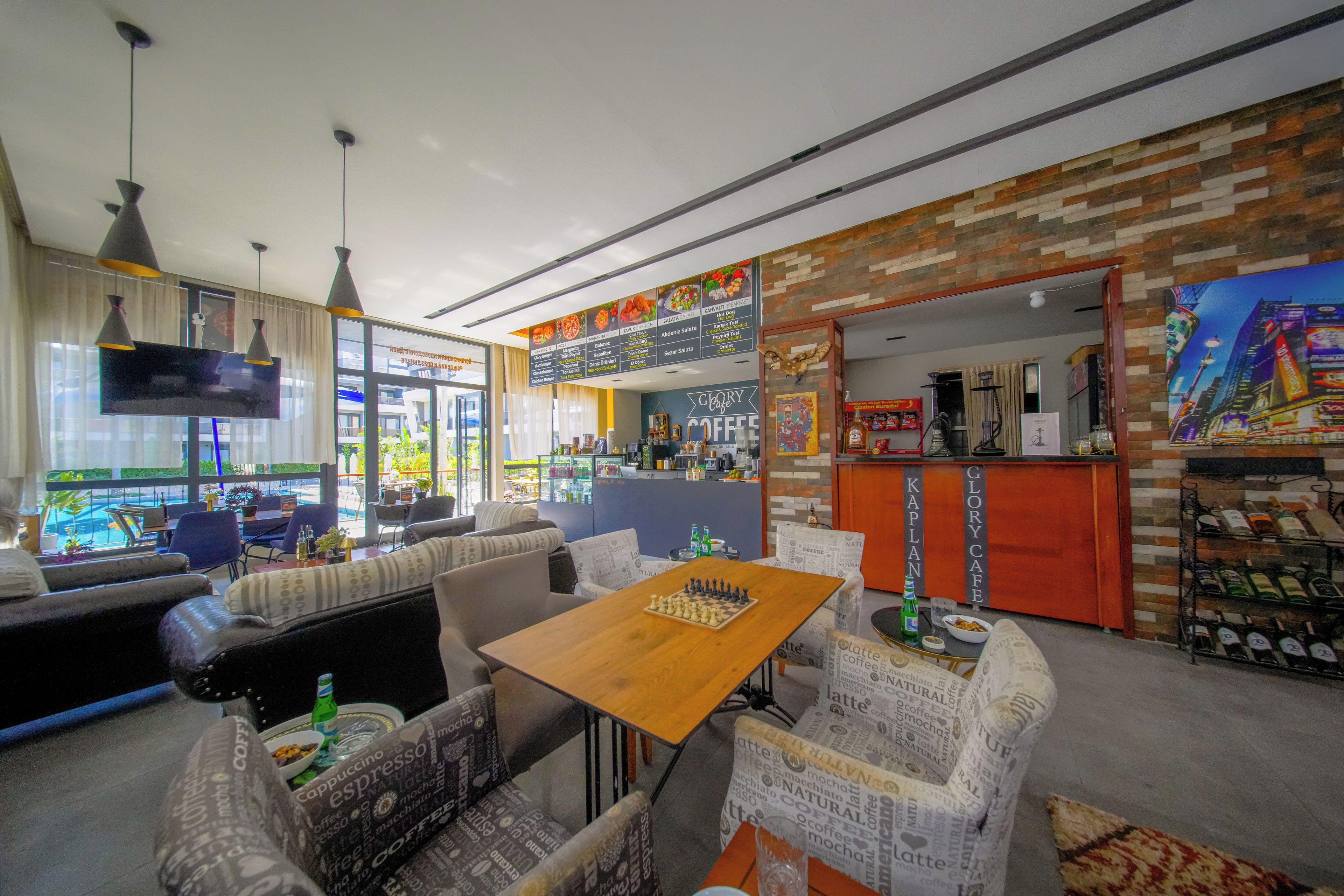 A café with a chessboard on a table, seating area, and a menu board.
