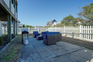 A patio with outdoor furniture and a propane tank.