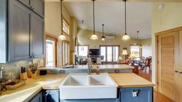 A kitchen with a central island, pendant lighting, and a view to the dining area.