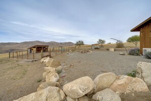 A rural property with a fenced area, a wooden structure, and a gravel driveway. - Hot Tub, Valley Views & 40 Acres in Methow (Pateros)