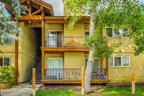 A multi-story building with balconies, wooden railings, and a staircase leading to an upper level. - Walk to Ski Slopes! Sun Valley Condo w/ Balcony (Ketchum)