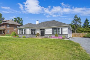A two-story house with a front porch, a chimney, and a well-maintained lawn. - Hot Tub & Fenced Yard! Family Escape in Lancaster (Lancaster)