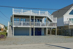 A two-story building with a balcony, a garage, and a sign that reads 'Salty Chateau.' - Steps to Beach! Topsail Island Retreat (Holly Ridge)