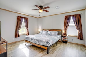 A bedroom with a bed, nightstands, a ceiling fan, and windows with curtains. - Easy I-4 Access: Central Florida Home w/ Fire Pit (Plant City)