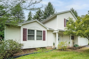 A two-story house with a front porch, a garage, and a well-maintained lawn. - Explore Brockport! Family Gem, Neighborhood Perks (Brockport)